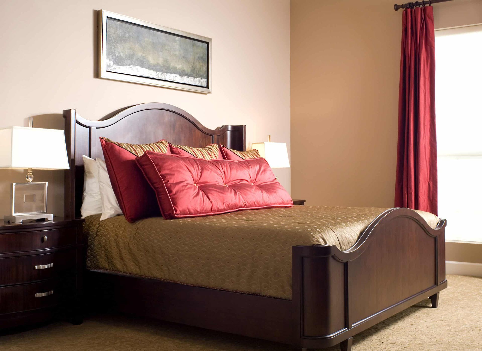 A bedroom with a large bed and red curtains
