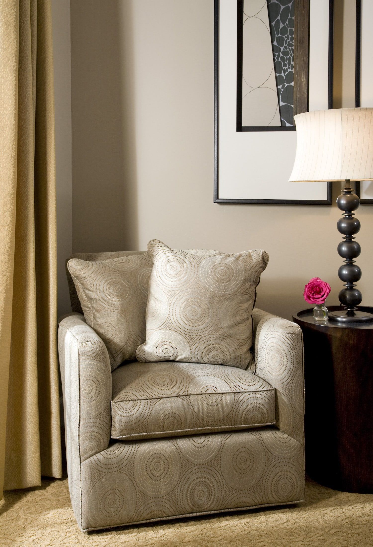 A chair with a pillow and a lamp in a room