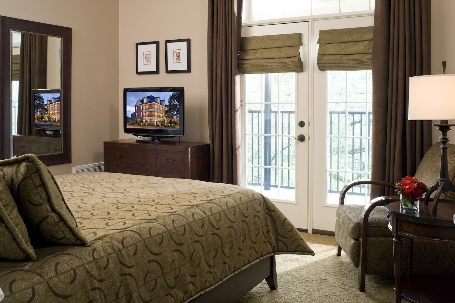 A bedroom with a king size bed and a flat screen tv