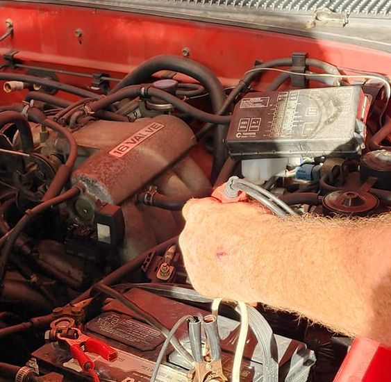 Person checking on a car battery | The Shop on Vieques, LLC