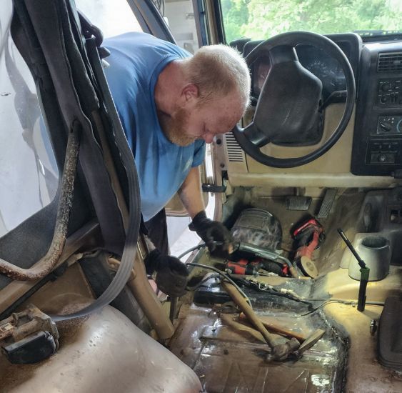 Person working on a car | The Shop on Vieques, LLC