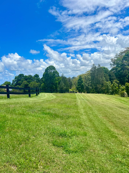 A Man Is Riding A Lawn Mower In A Field Next To A Soccer Goal — The Garden Folk In Lennox Head, NSW