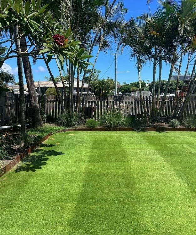 A Lush Green Lawn With Flowers In Front Of A House — The Garden Folk In Lennox Head, NSW