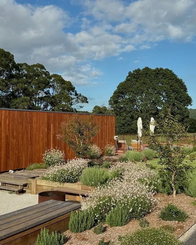 A Walkway Leading To A House With Lots Of Plants In Front Of It — The Garden Folk In Ballina, NSW