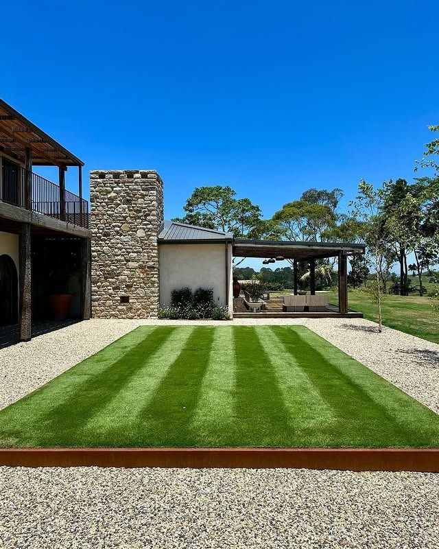 A lush green lawn with a wooden walkway in the background — The Garden Folk In Ballina, NSW