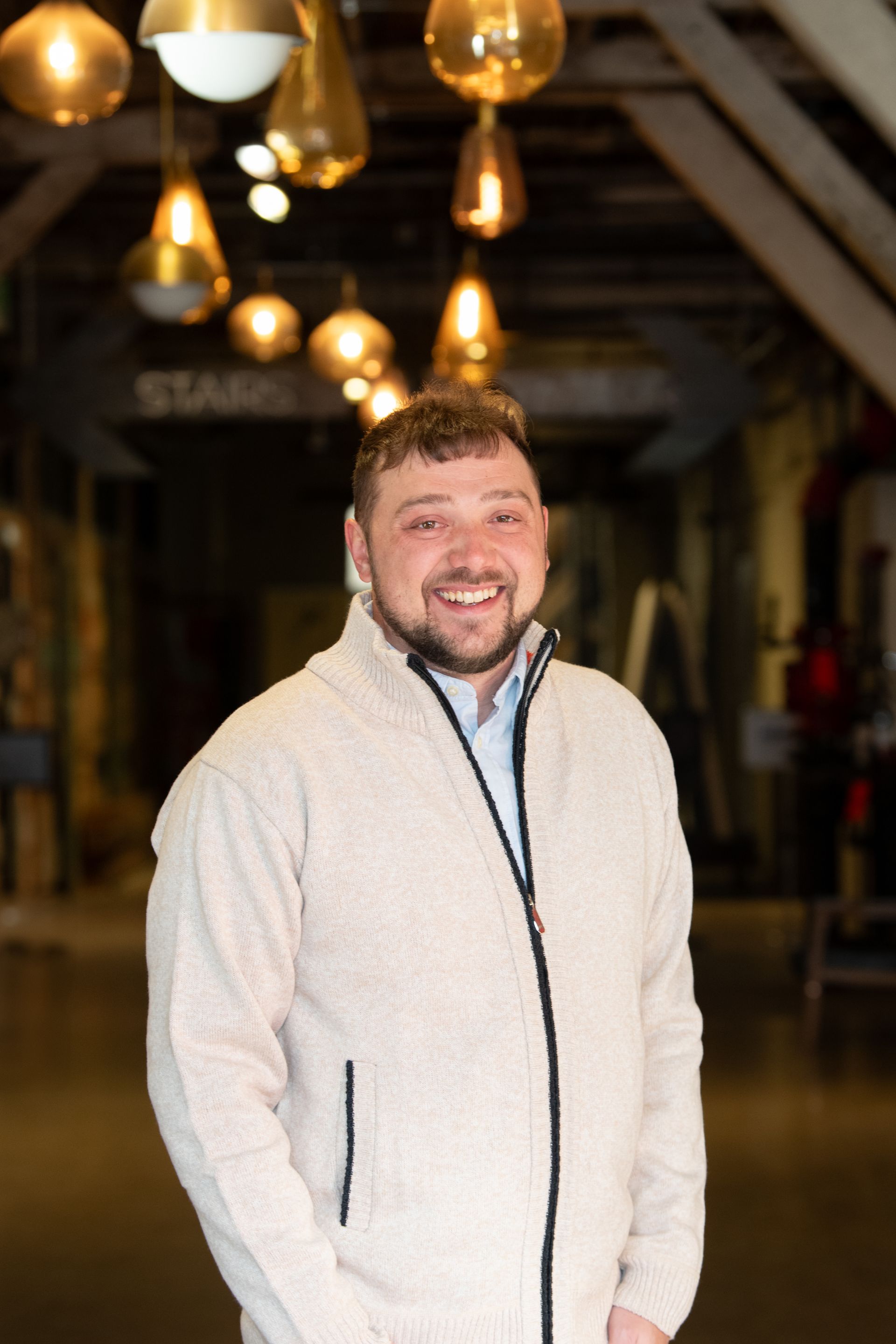 A man and a woman are sitting on a dock overlooking a lake.