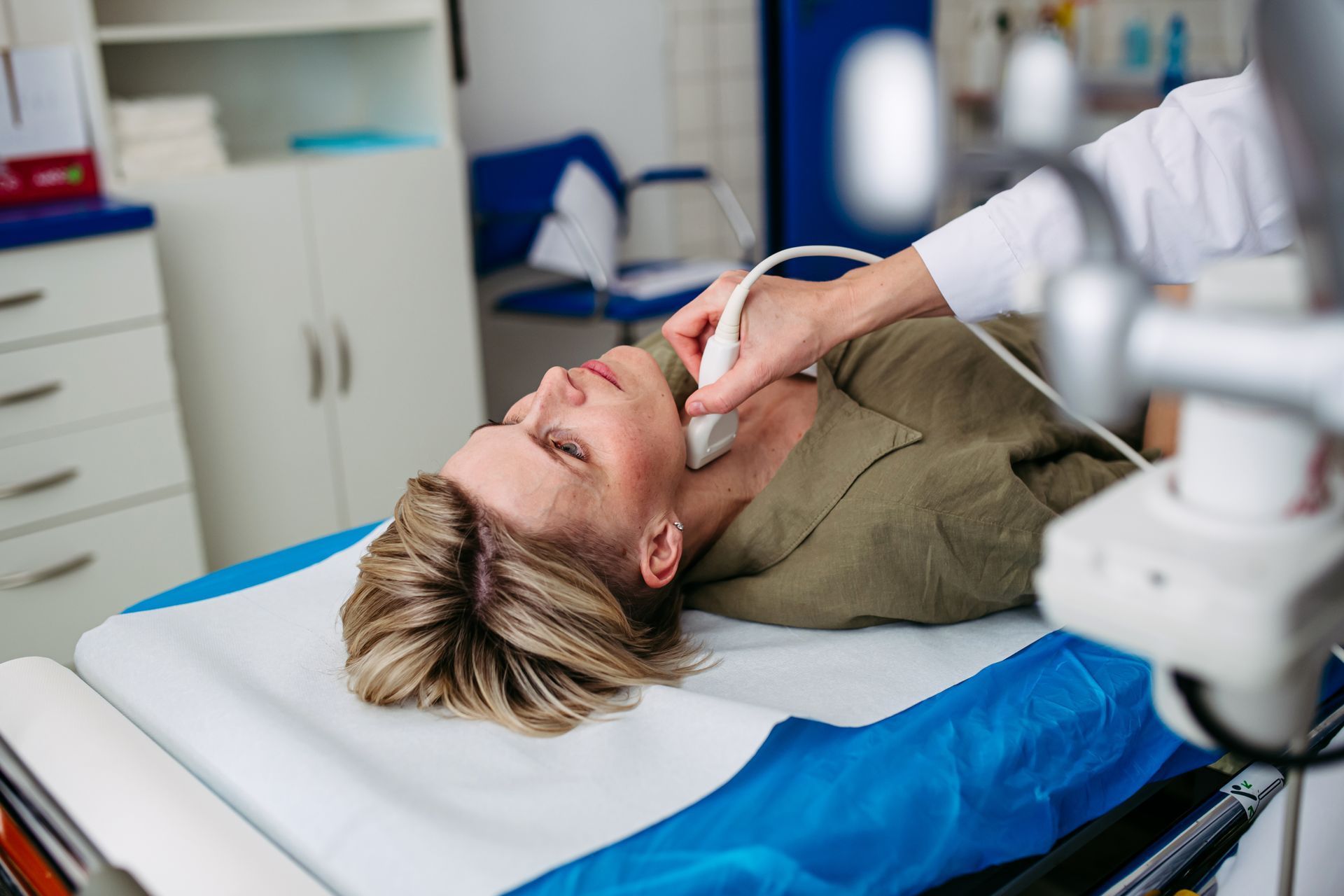 Person undergoing neck ultrasound in a medical setting Person undergoing neck ultrasound in a medical setting