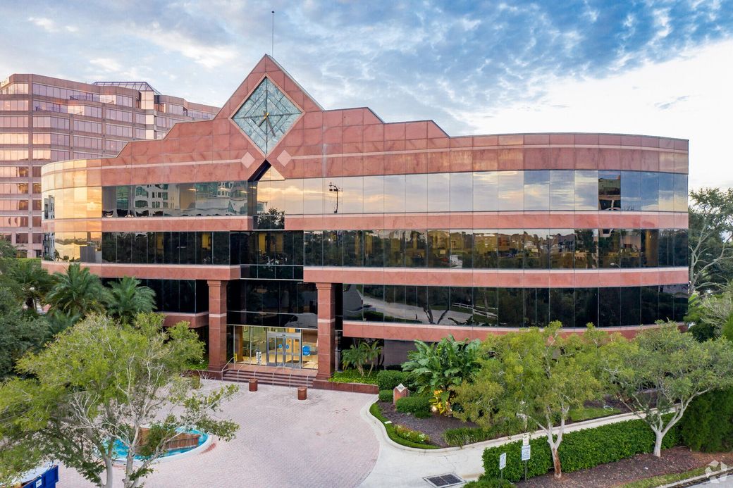 Patient lying on a CT scanner bed, preparing for a medical scan. Doctor standing nearby.