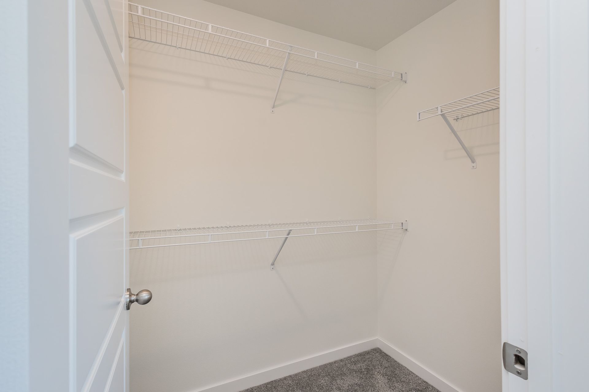 A walk-in closet with shelves.