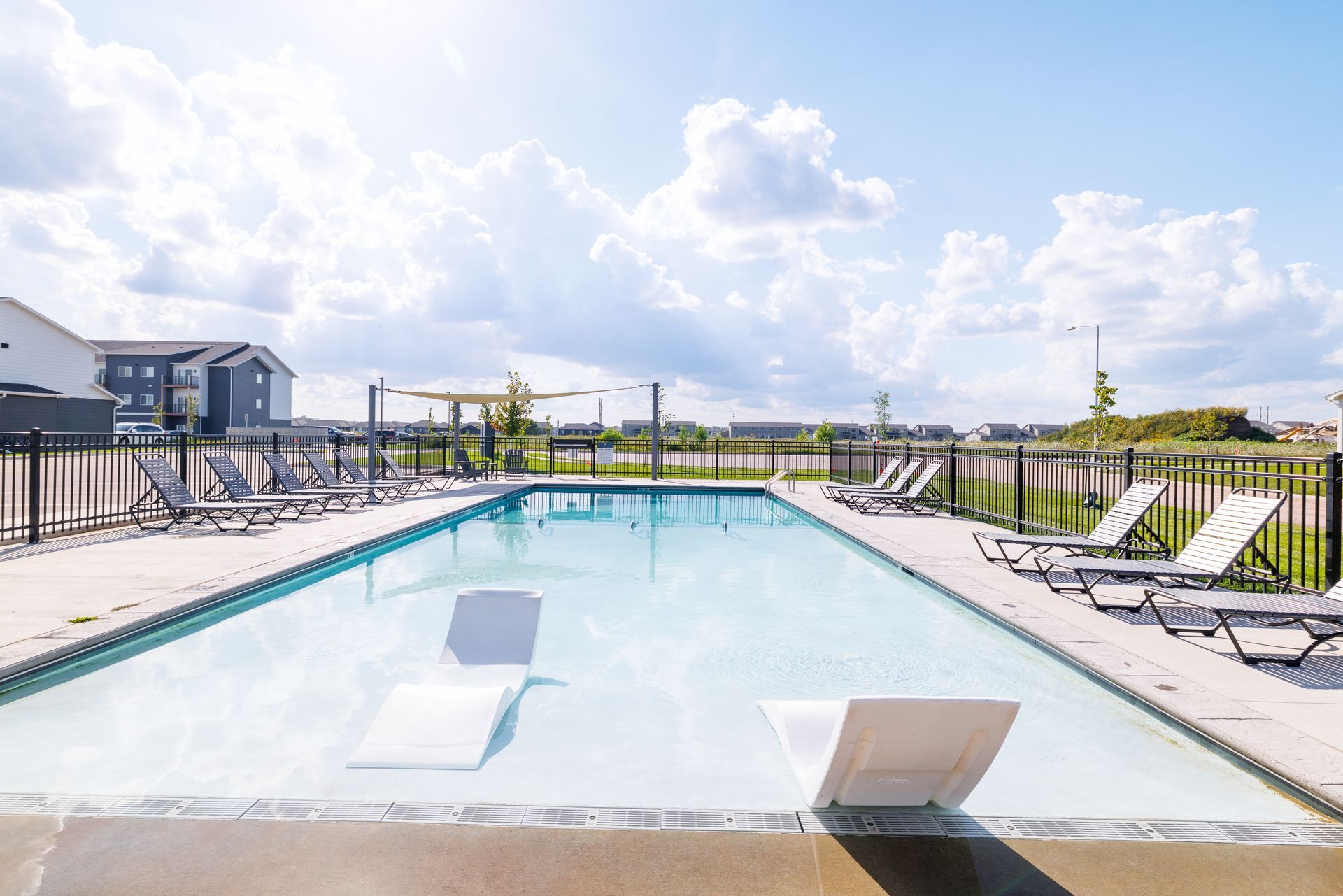 Outdoor pool with lounge chairs.