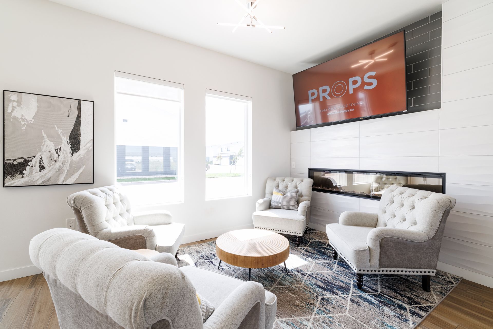 Clubhouse with sofa chairs and a television.