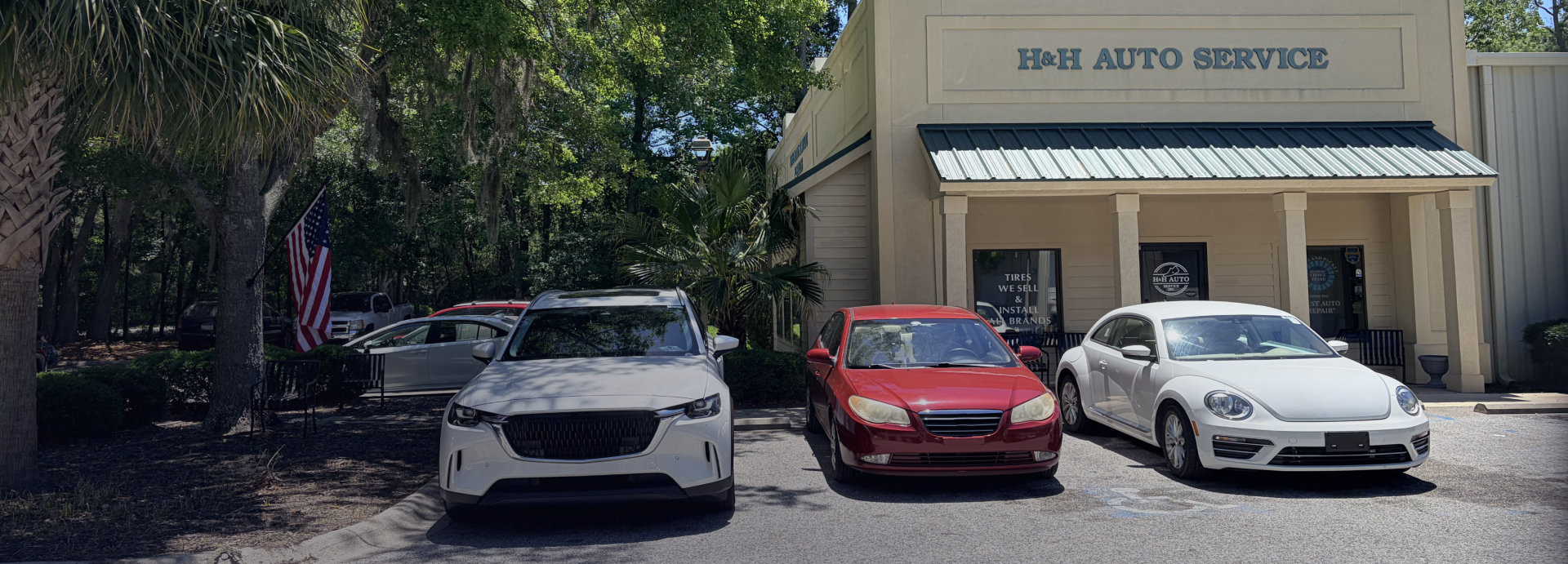 Small beige building with green awnings and the sign “B&H AUTO SERVICE” above the entrance.