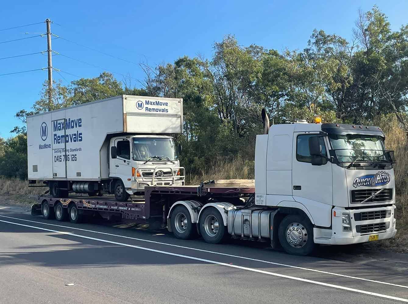 Two Trucks Are Parked on the Side of the Road — Quick Hitch Towing & Tilt Tray Services Illawarra in Shellharbour, NSW