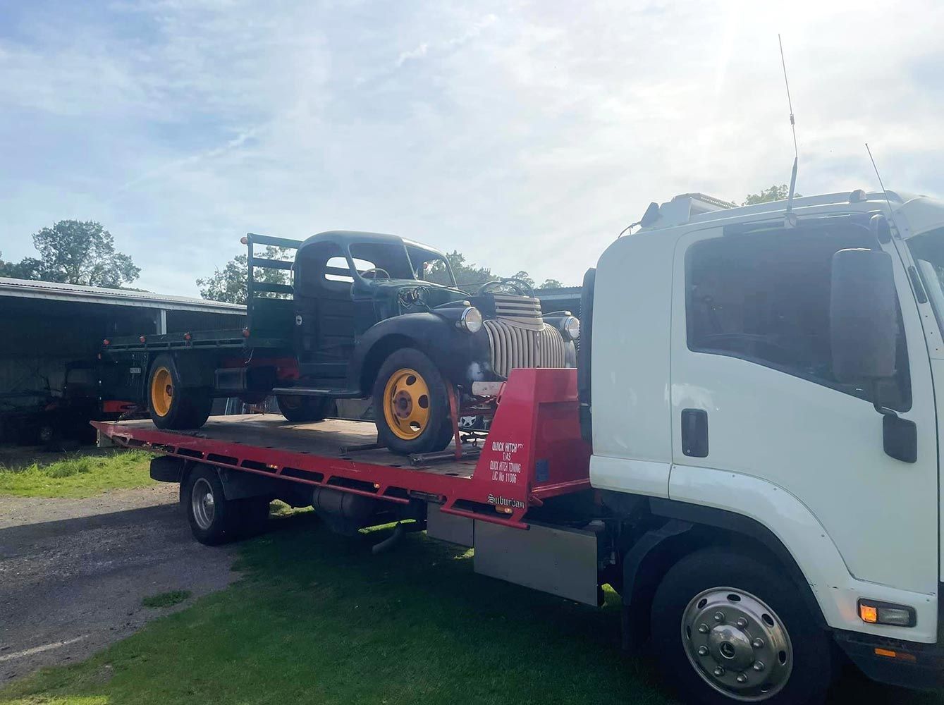 An Old Truck is Being Towed by a Tow Truck — Quick Hitch Towing & Tilt Tray Services Illawarra in Helensburgh, NSW