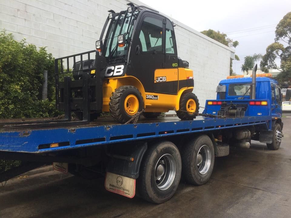 A Forklift is Sitting on Top of a Blue Tow Truck — Quick Hitch Towing & Tilt Tray Services Illawarra in Albion Park, NSW
