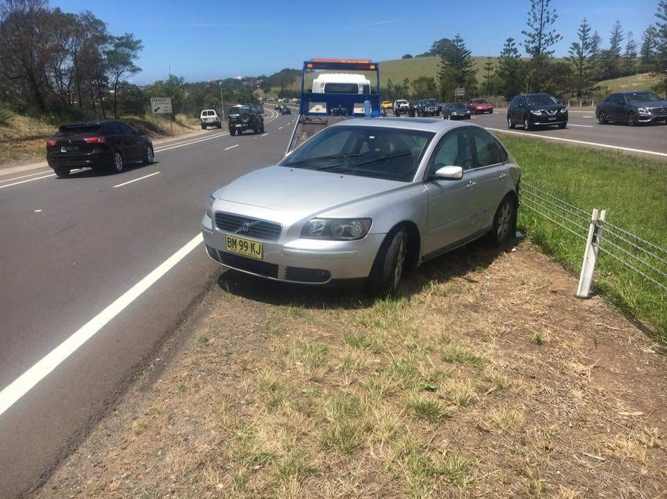 A Silver Car is Parked on the Side of the Road — Quick Hitch Towing & Tilt Tray Services Illawarra in Dapto, NSW
