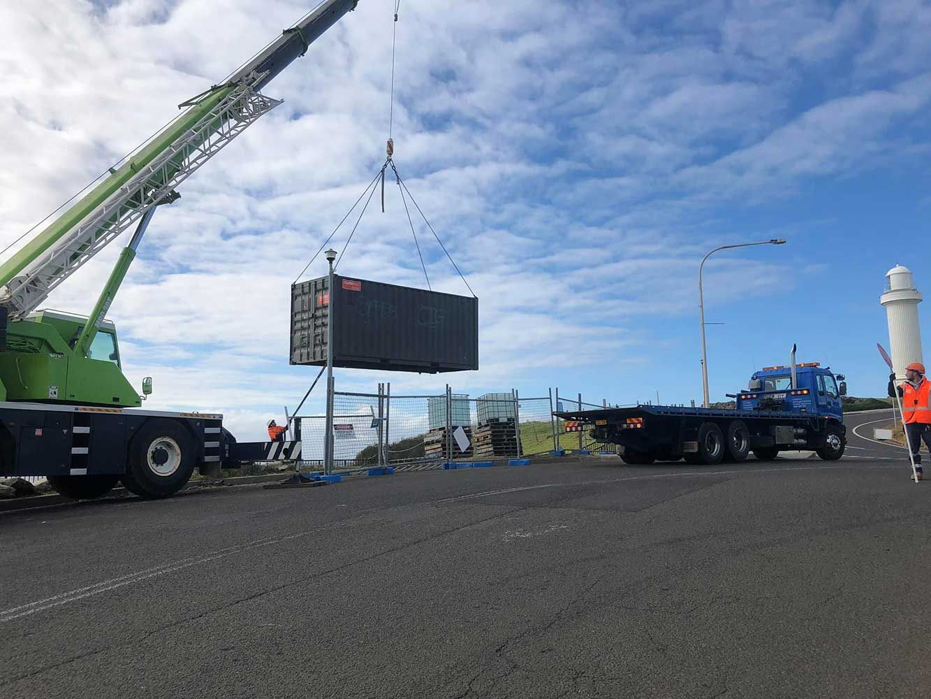 A Crane is Lifting a Container on a Truck — Quick Hitch Towing & Tilt Tray Services Illawarra in Oak Flats, NSW