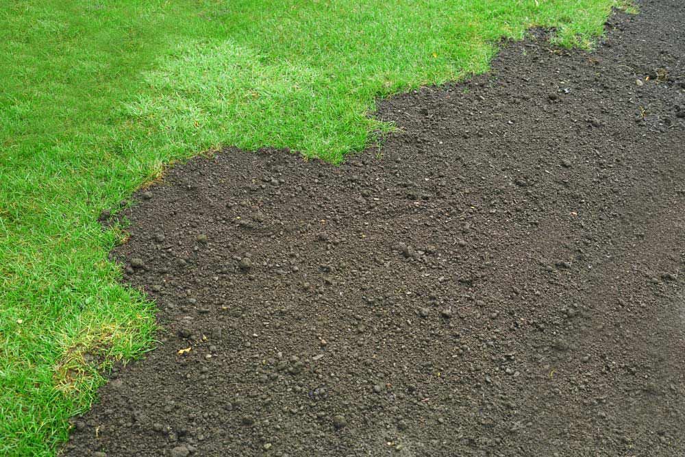 A Pile Of Dirt Next To A Lush Green Lawn — Joe's Turf In Ipswich, QLD