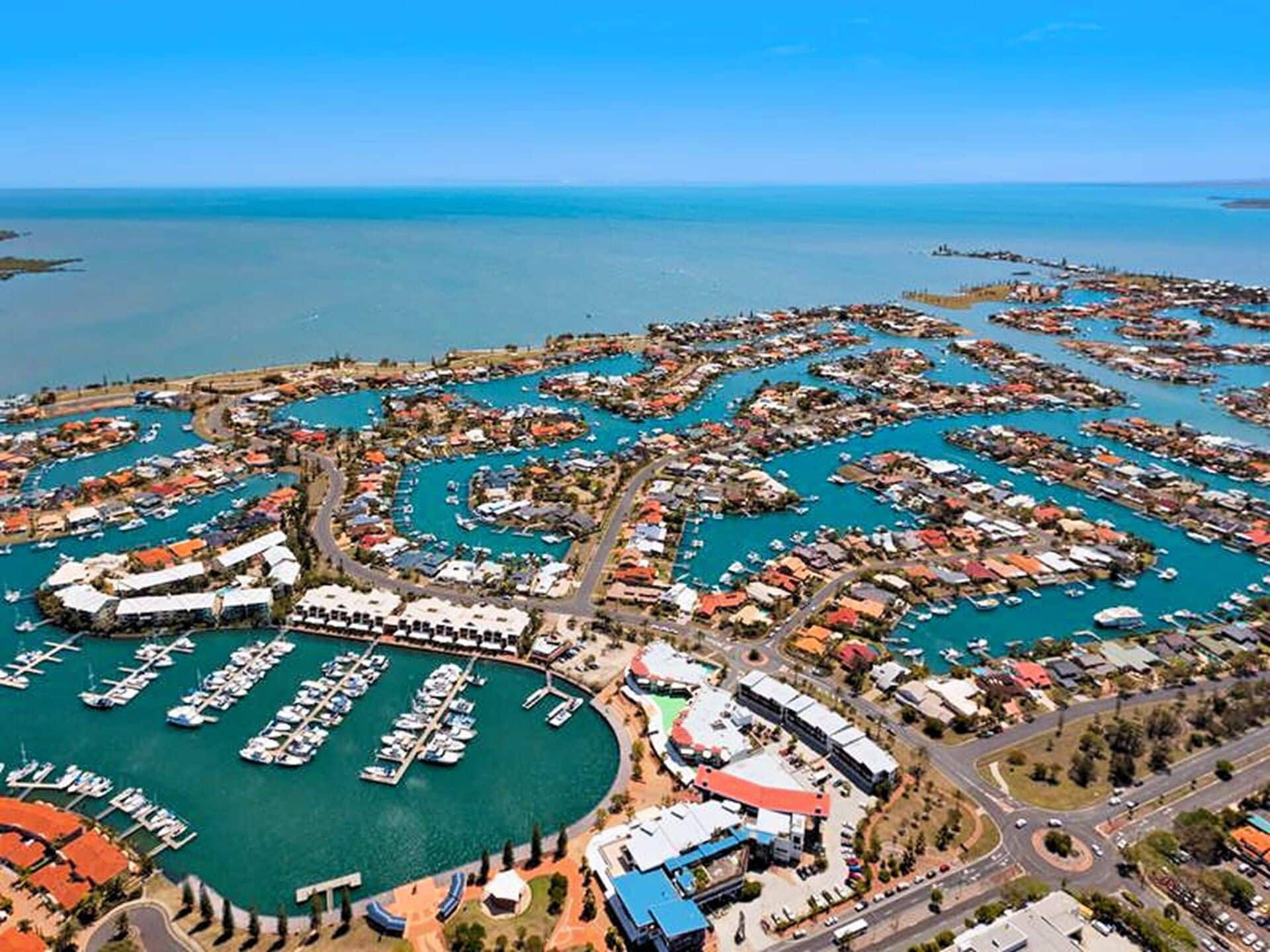 A Fence Surrounds A Grassy Field With A River In The Background — Joe's Turf In Cleveland, QLD
