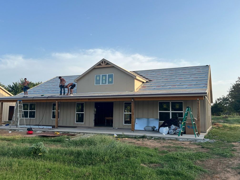 An empty living room with hardwood floors and a ceiling fan.