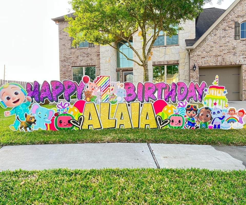 A happy birthday sign in front of a house