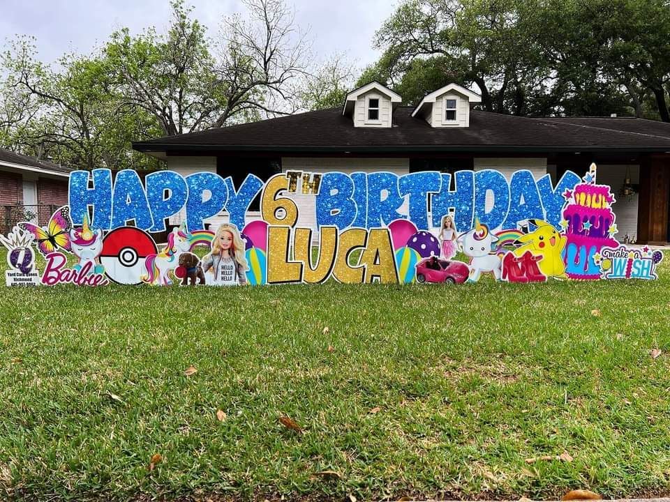 A happy birthday sign is in front of a house.