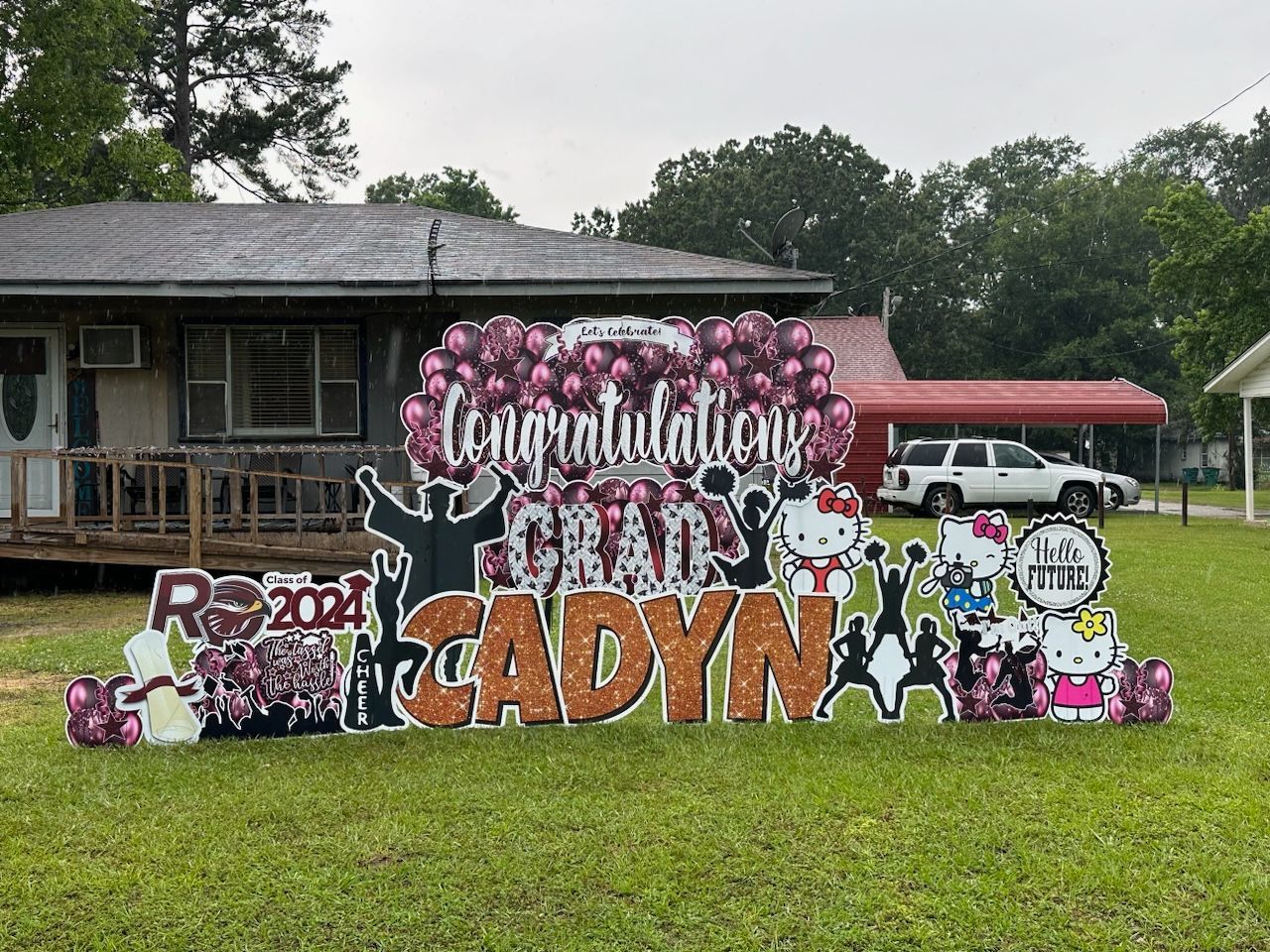 A congratulations sign is in front of a house.