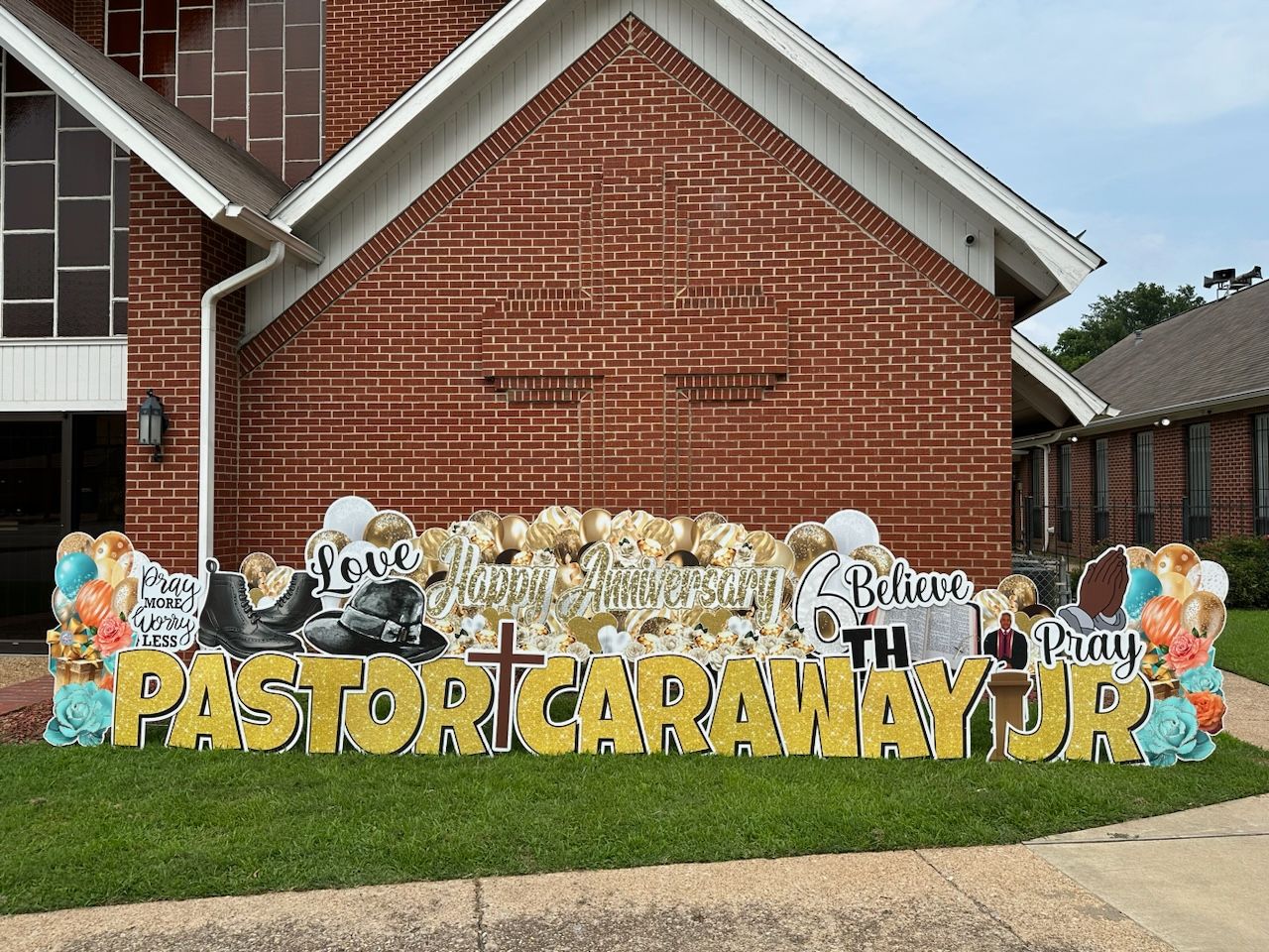 A large sign in front of a brick building that says `` pastor caraway jr. ''