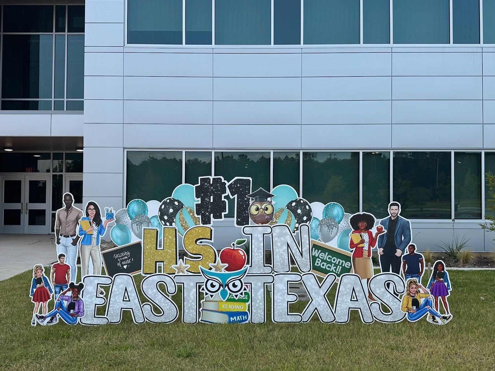 A large sign that says `` hs in east texas '' is in front of a building.