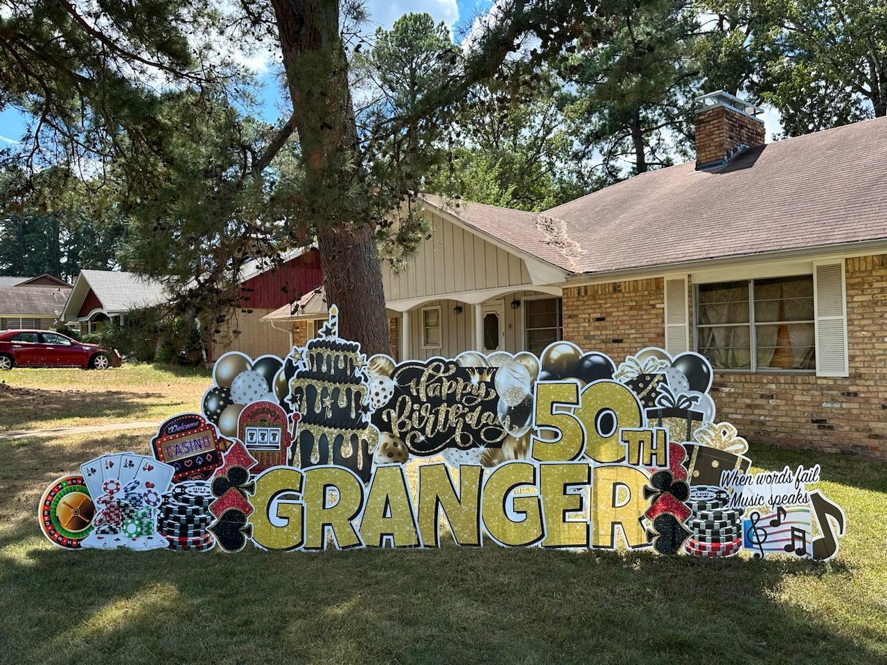A 50th birthday sign is in front of a house.