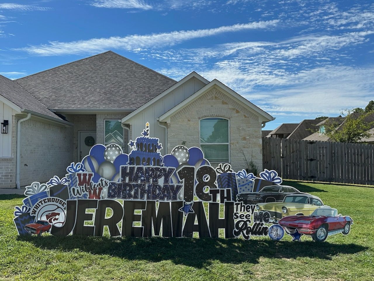 A birthday sign for jeremiah is in front of a house.