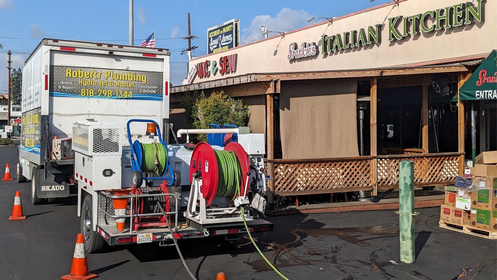 Truck with hoses in front of 