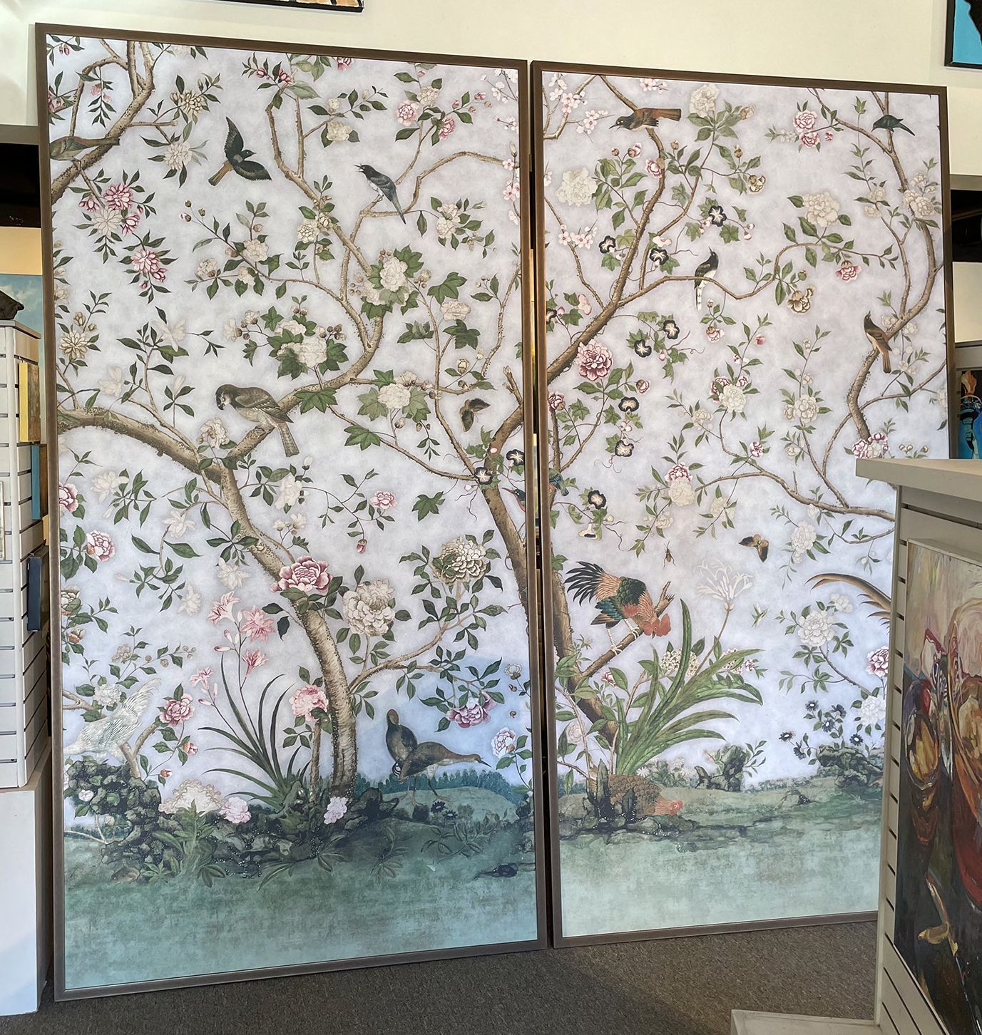 A painting of a tree with flowers and birds on it