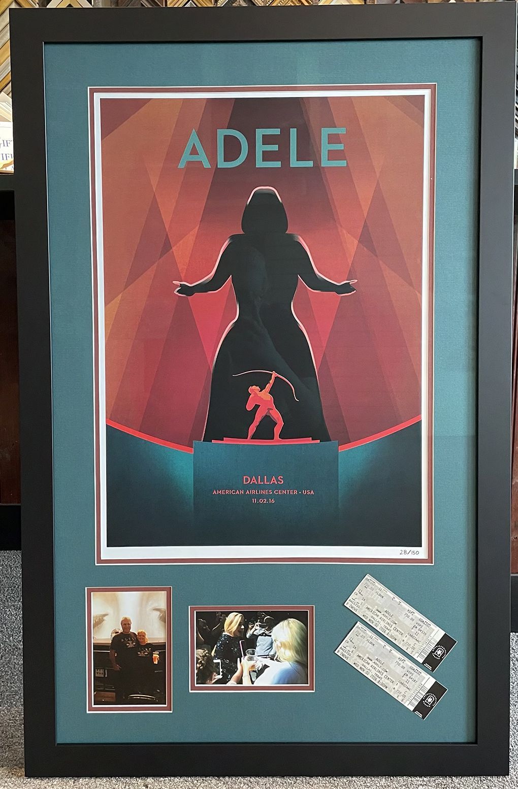 A framed poster of a woman named adele