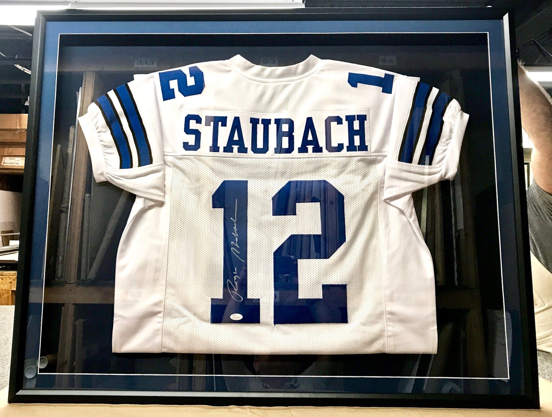A framed football jersey with the name staubach on it