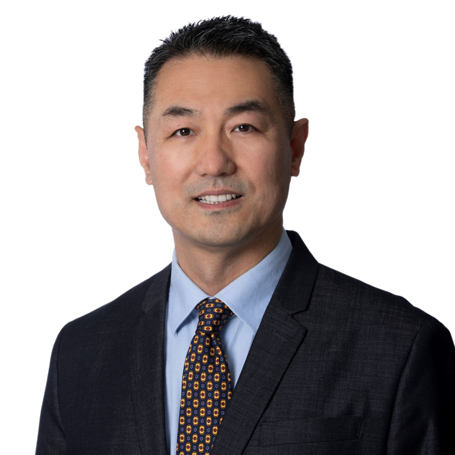 A man in a suit and tie is smiling for the camera.