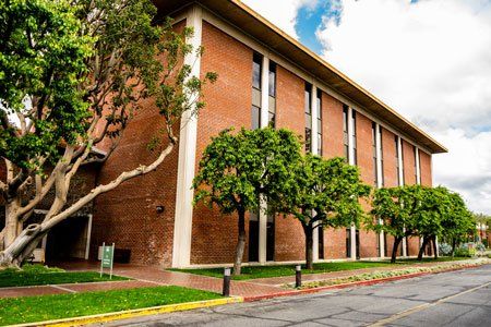 A large brick building with trees in front of it.