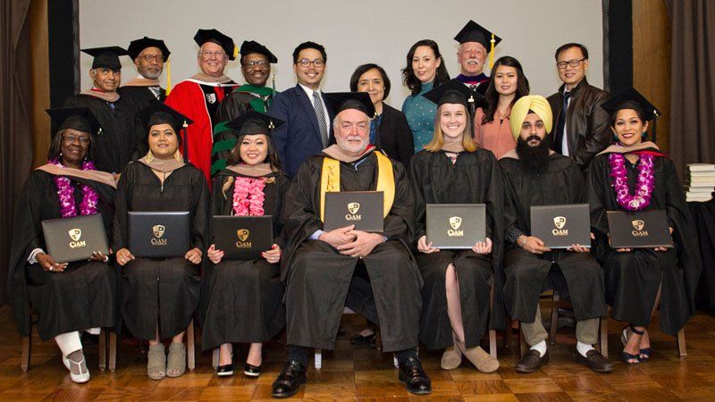 A group of graduates are posing for a picture together.