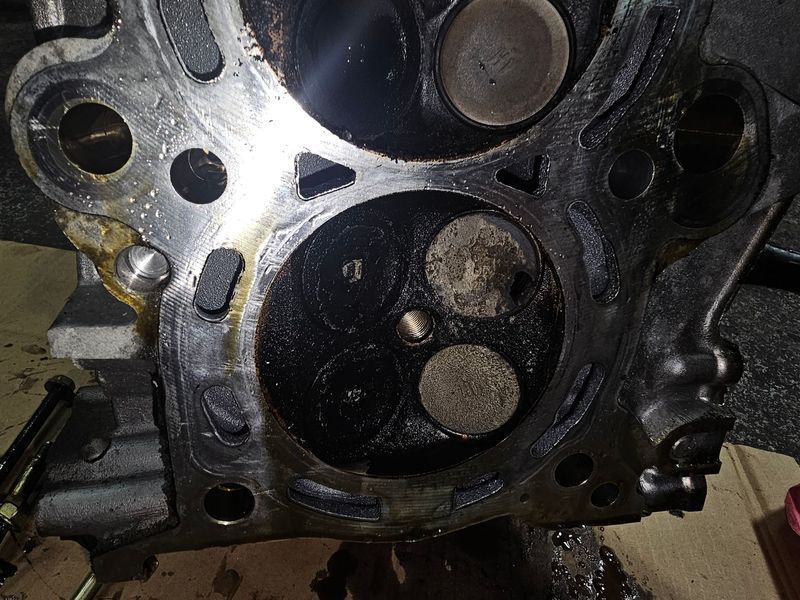 A close up of a cylinder head of a car engine.