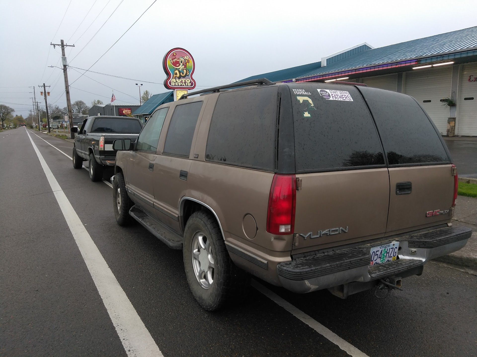 SUV Waiting Outside Auto Repair Shop On City Street | AJ’s Auto Repair