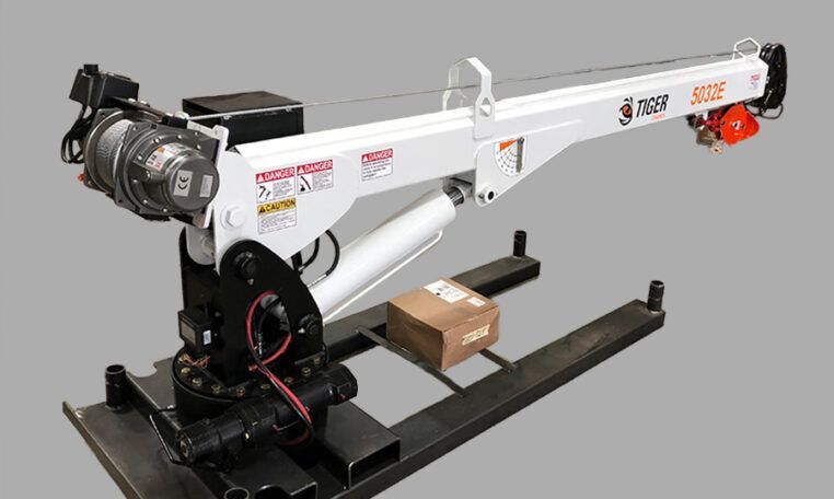 White Tiger brand crane lifting a brown box on a black base.