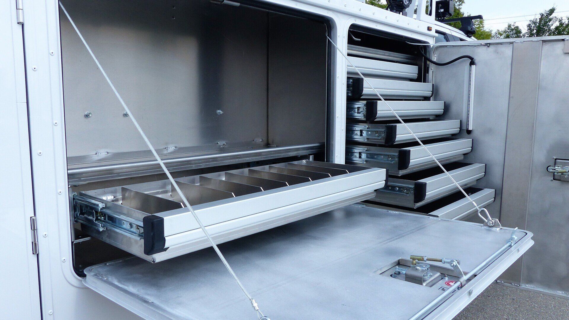 A stainless steel toolbox with drawers pulled out of it.