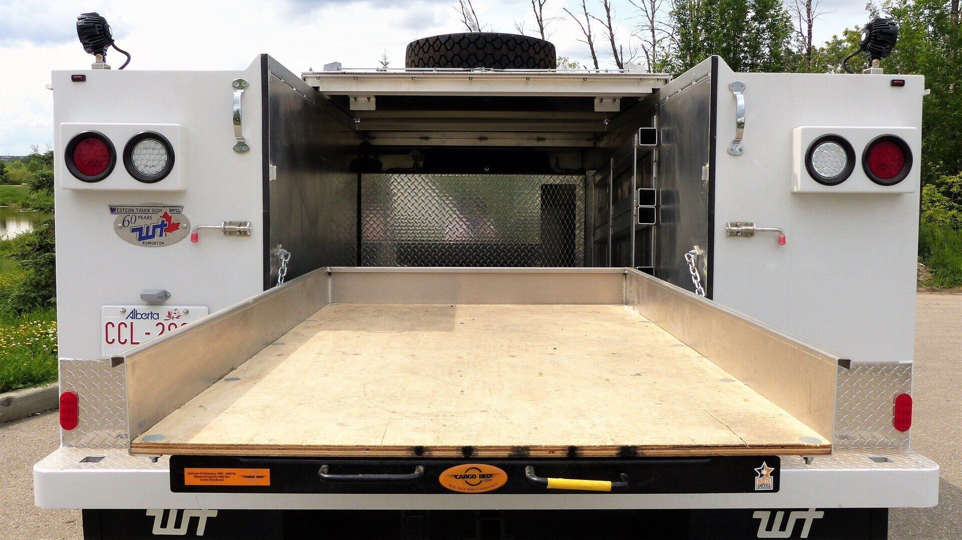 The back of a white truck with the word wt on it