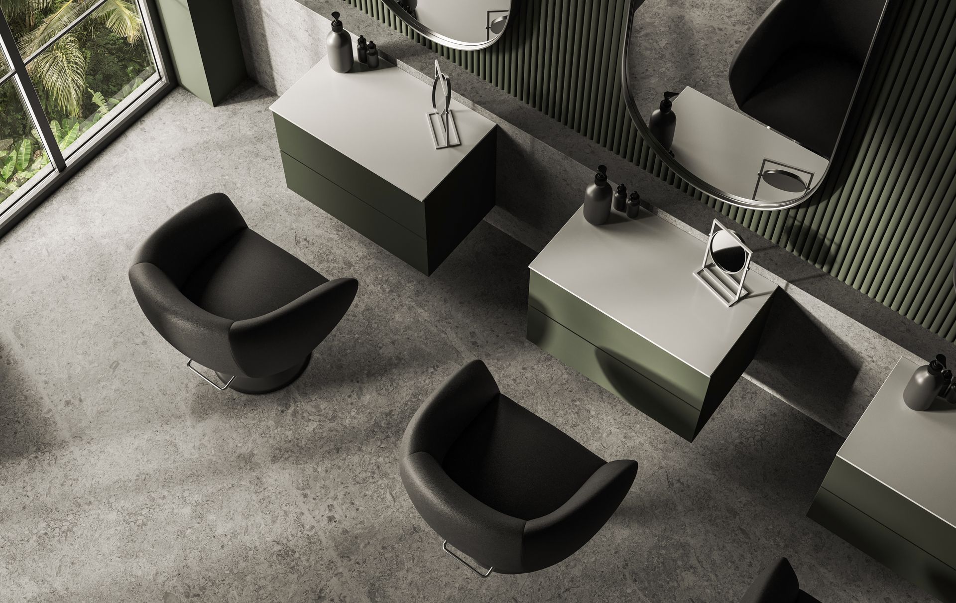Modern restroom with black lounge chairs, gray sinks, and large wall mirrors on a textured floor.