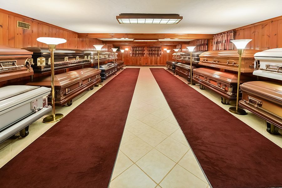 John F. Fluehr & Sons, Inc showroom, showcasing rows of closed caskets on display