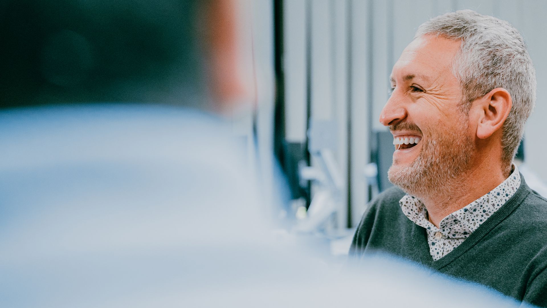 A zoi employee smiling at the camera