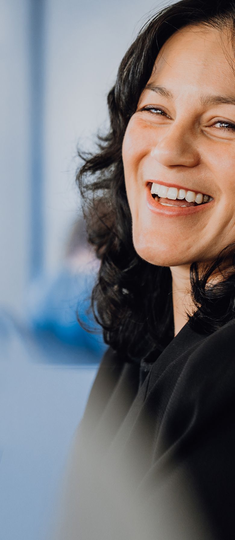 A zoi employee smiling at the camera