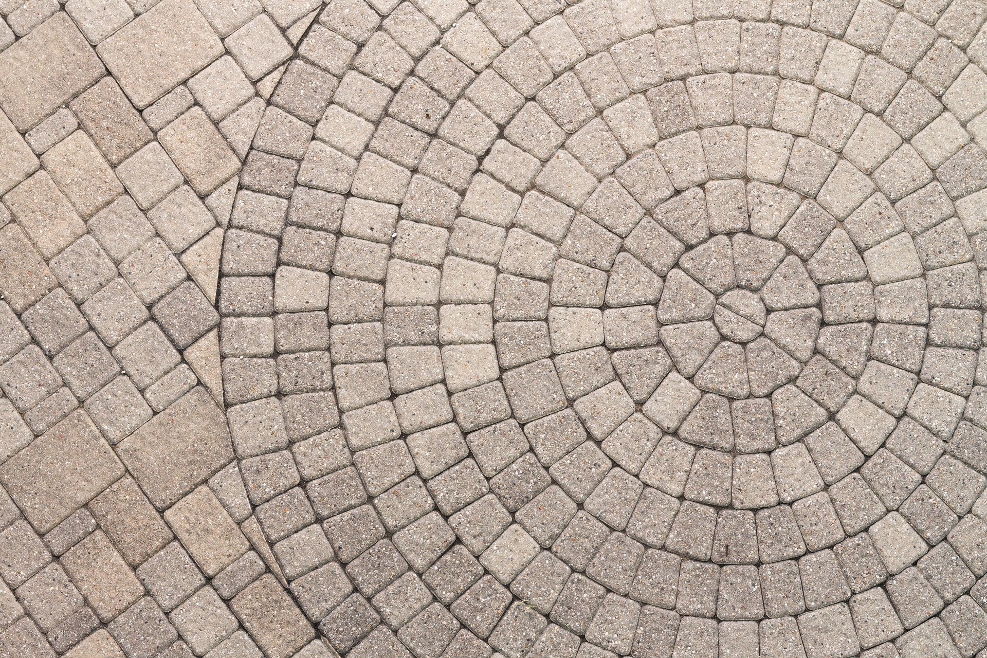 A close up of a circular pattern on a brick floor.