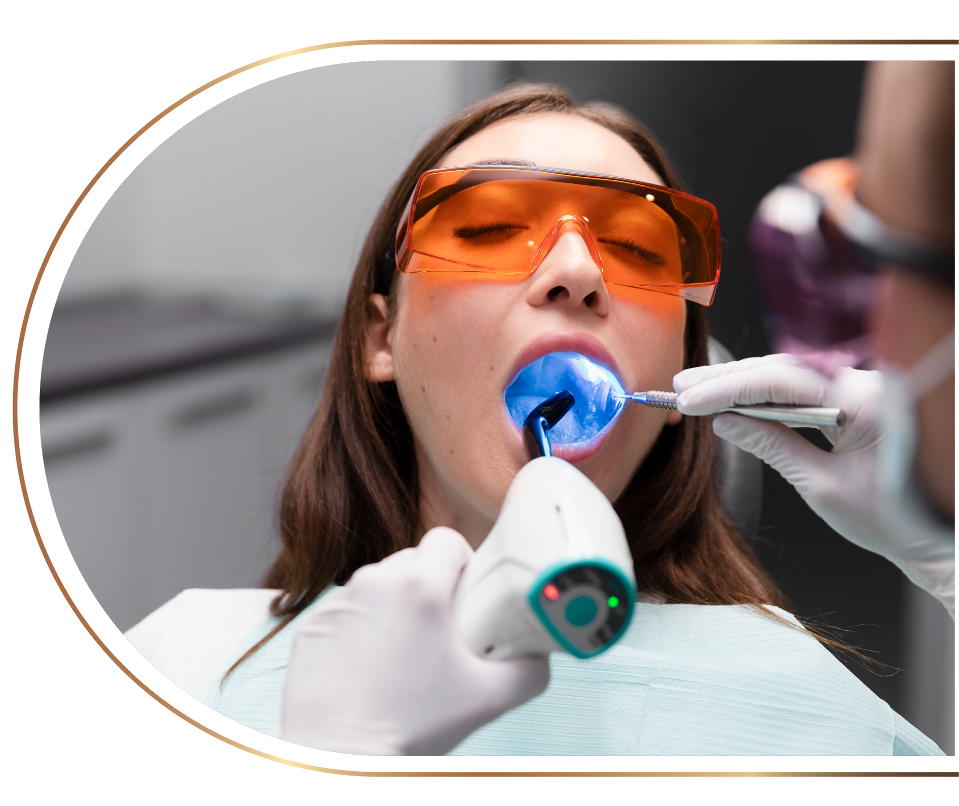 A woman is getting her teeth whitened by a dentist.