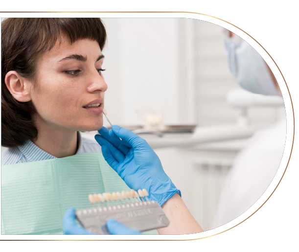 A woman is sitting in a dental chair while a dentist examines her teeth.